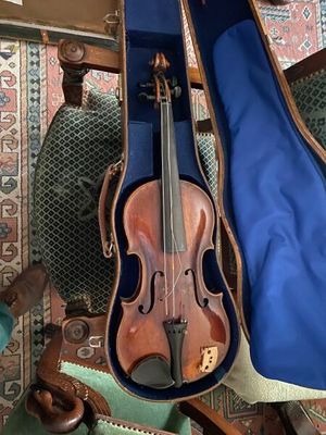 a violin that is sitting in a case on a chair