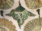 many different types of umbrellas hanging on the wall