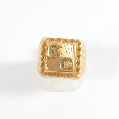an image of a gold ring on a white surface