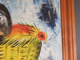 a painting of a chicken in a basket hanging on a wall