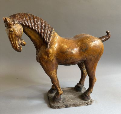 statue of a horse on a stone base on a white background