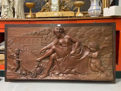 a bronze statue of a woman sitting on a table