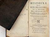 an old book sitting on top of a white table
