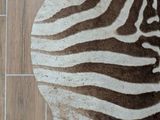 a zebra rug on the floor next to a wall