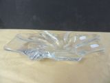 a clear glass bowl sitting on a table with a black background