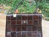 a small brown purse sitting on a wooden table