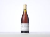a bottle of wine sitting on top of a white table