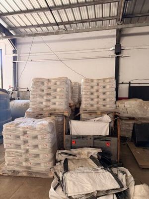 a large pile of boxes and bags in a warehouse