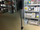 a camera on a tripod in a room with shelves