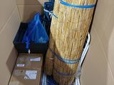 a broom in a cardboard box with a blue ribbon