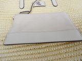 a white purse with a pair of glasses on top of it