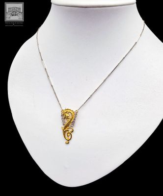 a close up of a necklace on a mannequin mannequin