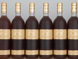 six bottles of wine lined up in a row on a table