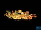 some very pretty colored crystals on a black surface
