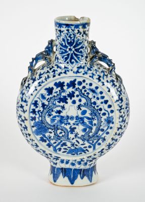 blue and white porcelain vase with dragon handles on a white background