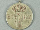 an image of a silver medal with a crown on it