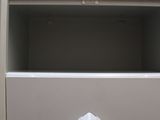 a close up of a filing cabinet with a drawer underneath it