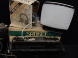 a small television sitting on top of a box next to a keyboard