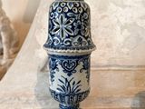 a blue and white vase sitting on top of a table