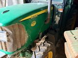 a tractor that is parked in a building with bricks