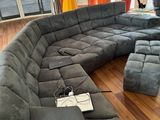 an image of a living room with a large sectional couch
