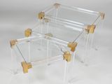 two clear acrylic tables with wooden legs and a clear glass top