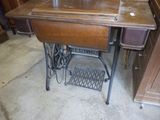 une machine à coudre posée sur une table en bois