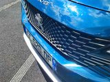 a blue car that is parked in a parking lot