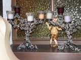 three candles that are sitting on a shelf in front of a window