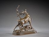 an image of a bronze sculpture of a deer and a deer on a rock