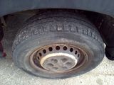 a close up of a flat tire on a truck
