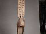 a wooden sculpture of a helmet on a stand