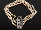 a pearl and diamond necklace with a clasp