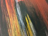 abstract painting of red, yellow, black, and white colors on a black surface