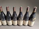 six bottles of wine are lined up in a row on a table