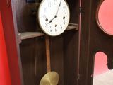 a clock that is sitting in the corner of a cabinet
