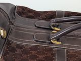 a close up of a purse with a handle on it