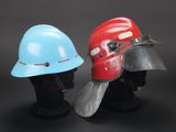 two helmets are sitting on a black surface with a red one and blue one