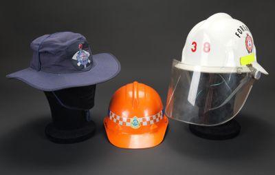 deux chapeaux et un casque de chantier sont posés les uns à côté des autres