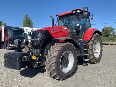 a red tractor that is parked in a parking lot