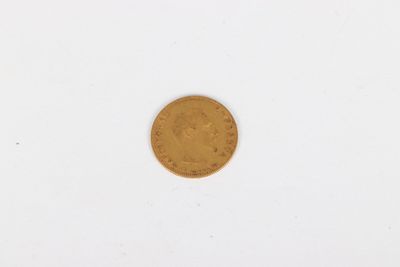 a close up of a gold coin on a white surface