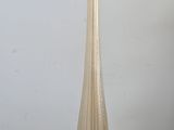 a tall glass vase on a table with a wooden base