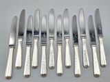 six knives and six knives on a table