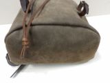 a brown bag with a brown handle on a white table