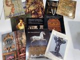 several books on a white table with a white horse on top of it