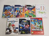 several nintendo wii games are lined up on a white surface