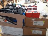 many boxes of clothing on a pallet in a warehouse