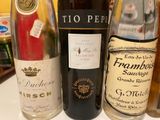 several bottles of wine are lined up on a counter