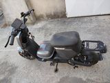 a scooter that is parked in a parking lot