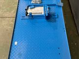a close up of a blue platform with a machine on it